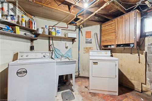 Dedicated laundry area with a utility sink, a top-loading washing machine, and a front-loading dryer - 25 East 39Th Street, Hamilton, ON - Indoor Photo Showing Laundry Room