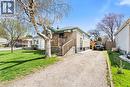Brick and stucco exterior with a covered front porch featuring wood railings - 25 East 39Th Street, Hamilton, ON  - Outdoor 