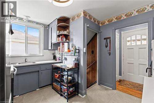 Kitchen featuring gray cabinetry, white countertops, and a double-basin sink - 25 East 39Th Street, Hamilton, ON - Indoor
