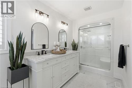 Double vanity with white cabinetry and light-toned countertop - 47 Winners Way, Binbrook, ON - Indoor Photo Showing Bathroom