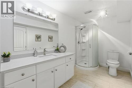 Bathroom featuring a white vanity with a light speckled countertop, an undermount sink, and a chrome faucet - 47 Winners Way, Binbrook, ON - Indoor Photo Showing Bathroom