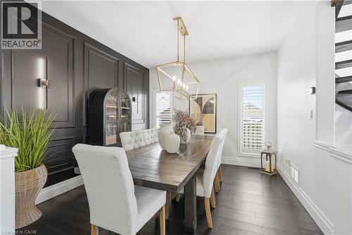 Formal dining area featuring dark wood-finish flooring - 47 Winners Way, Binbrook, ON - Indoor Photo Showing Dining Room