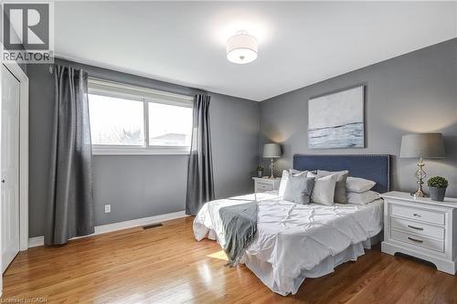 Hardwood flooring throughout featuring a neutral color palette - 217 Lawnhurst Court, Hamilton, ON - Indoor Photo Showing Bedroom