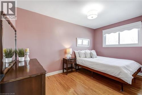 Room featuring light wood-finish flooring and a contemporary flush-mount ceiling light - 217 Lawnhurst Court, Hamilton, ON - Indoor Photo Showing Bedroom