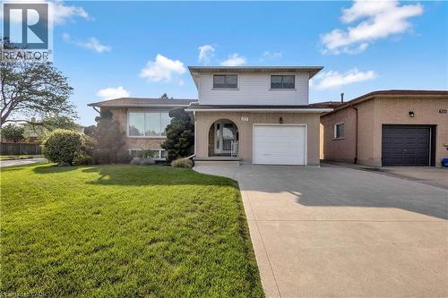 Two-story residence featuring a brick facade with an arched entry and an integrated garage - 217 Lawnhurst Court, Hamilton, ON - Outdoor