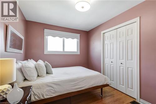 Room featuring wood-finish flooring, a double window, and bi-fold closet doors - 217 Lawnhurst Court, Hamilton, ON - Indoor Photo Showing Bedroom