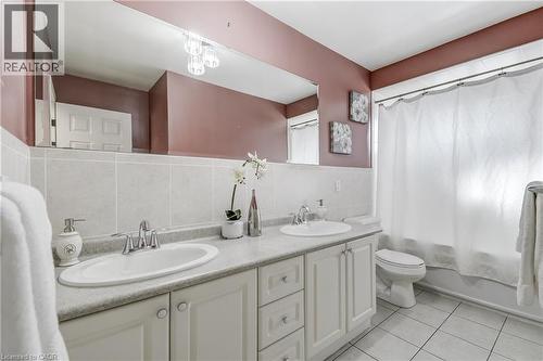 Dual vanity with white cabinetry and chrome fixtures - 217 Lawnhurst Court, Hamilton, ON - Indoor Photo Showing Bathroom