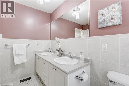 Dual vanity with undermount sinks, chrome fixtures, and a light-toned countertop - 217 Lawnhurst Court, Hamilton, ON - Indoor Photo Showing Bathroom
