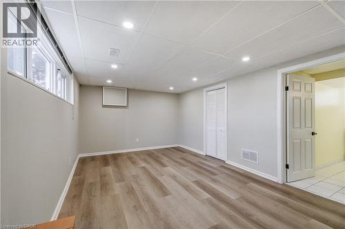 Finished lower level featuring wood-finish flooring, recessed lighting, and a drop ceiling - 217 Lawnhurst Court, Hamilton, ON - Indoor