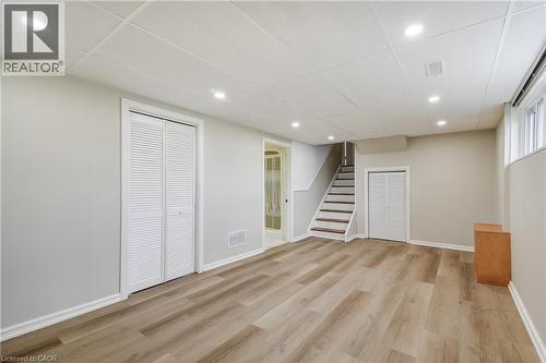 Spacious room featuring light wood-finish flooring, recessed lighting, and a white acoustical tile ceiling - 217 Lawnhurst Court, Hamilton, ON - Indoor