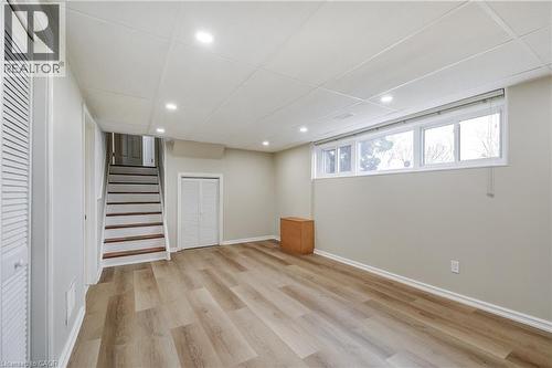 Spacious room featuring wood-finish flooring, recessed lighting, and a drop ceiling - 217 Lawnhurst Court, Hamilton, ON - Indoor