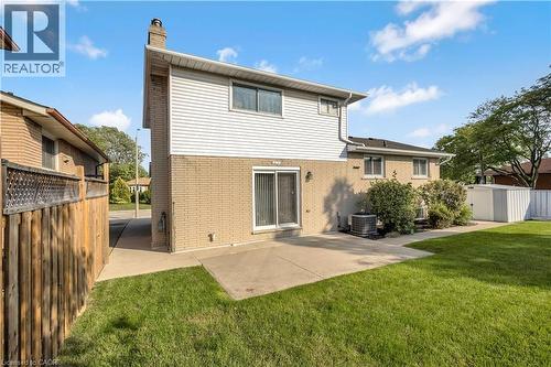 Spacious backyard featuring a manicured lawn and concrete patio - 217 Lawnhurst Court, Hamilton, ON - Outdoor