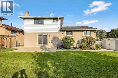 Expansive backyard featuring a lush lawn, a concrete patio, and mature shrubbery - 217 Lawnhurst Court, Hamilton, ON - Outdoor