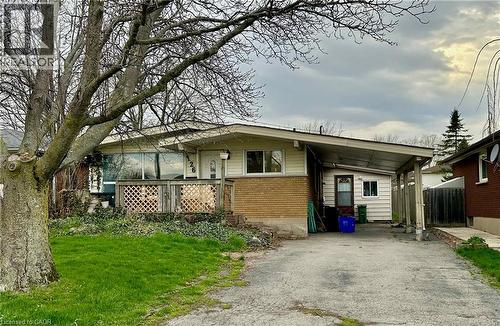 Ranch-style exterior featuring a combination of brick and siding, a covered front porch with lattice detailing, large picture windows, and a driveway leading to a covered carport - 126 Lilacside Drive, Hamilton, ON - Outdoor