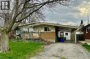 Ranch-style exterior featuring a combination of brick and siding, a covered front porch with lattice detailing, large picture windows, and a driveway leading to a covered carport - 126 Lilacside Drive, Hamilton, ON  - Outdoor 
