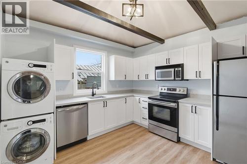 Contemporary kitchen featuring white shaker cabinetry and light countertops - 149 Lottridge Street, Hamilton, ON - Indoor Photo Showing Laundry Room