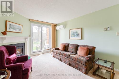 123 - 440 Wellington Street, St. Thomas, ON - Indoor Photo Showing Living Room With Fireplace