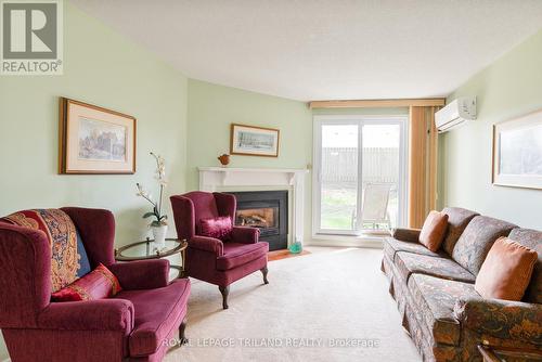 123 - 440 Wellington Street, St. Thomas, ON - Indoor Photo Showing Living Room With Fireplace