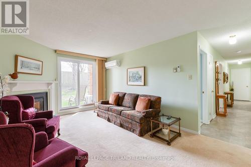 123 - 440 Wellington Street, St. Thomas, ON - Indoor Photo Showing Living Room With Fireplace