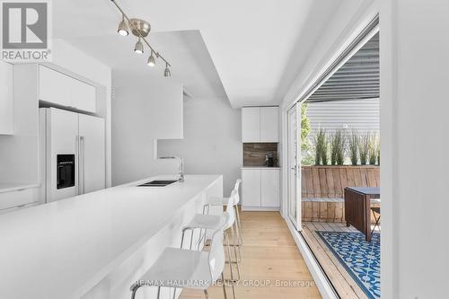 Bright kitchen with sleek modern finishes - 330 Winona Avenue, Ottawa, ON - Indoor Photo Showing Kitchen With Double Sink