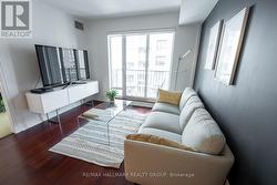 Living Room w/Hardwood Floors and Walk-Out Balcony - 