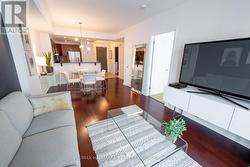 Living Room w/Hardwood Floors and Walk-Out Balcony - 