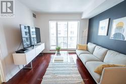 Living Room w/Hardwood Floors and Walk-Out Balcony - 