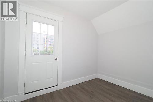 White paneled door with a multi-pane glass insert and polished door hardware - 205 Duke Street E, Kitchener, ON - Indoor Photo Showing Other Room