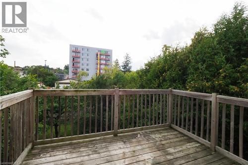 Outdoor wooden deck space featuring a slatted wood railing - 205 Duke Street E, Kitchener, ON - Outdoor