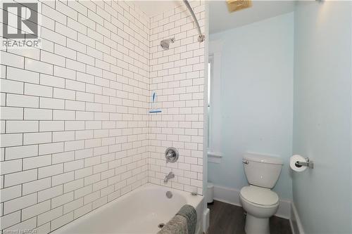 White subway tile shower surround with a built-in tub and chrome fixtures - 205 Duke Street E, Kitchener, ON - Indoor Photo Showing Bathroom