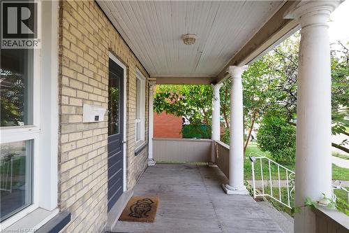 Inviting front porch featuring classic columns and a beadboard ceiling - 205 Duke Street E, Kitchener, ON - Outdoor With Deck Patio Veranda With Exterior