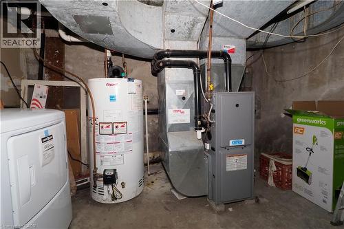 Utility area featuring a water heater, furnace, and exposed ductwork - 205 Duke Street E, Kitchener, ON - Indoor Photo Showing Basement