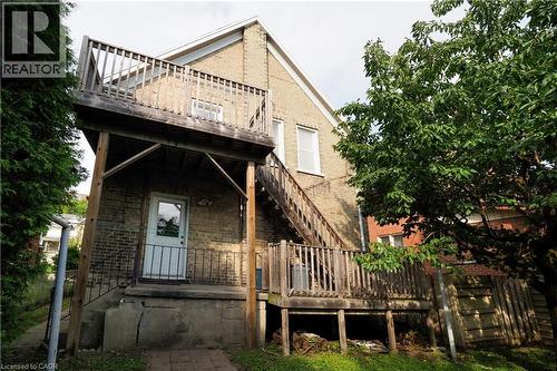 Brick exterior featuring a two-story wood deck and wood staircase - 205 Duke Street E, Kitchener, ON - Outdoor