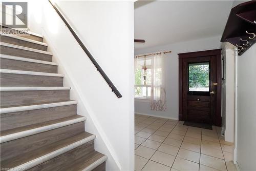 Entryway featuring light-toned tile flooring and a dark wood-finish door with a glass panel - 205 Duke Street E, Kitchener, ON - Indoor Photo Showing Other Room