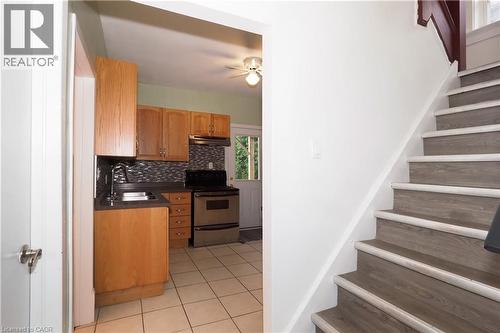 Wood-finish staircase with white risers and trim - 205 Duke Street E, Kitchener, ON - Indoor