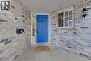 Entryway featuring a blue door with a transom window and sidelight, set against a two-tone brick facade - 512 Hidden Creek Drive, Kitchener, ON  - Outdoor 