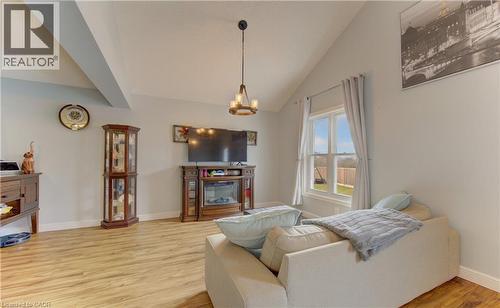Vaulted ceiling with exposed beam, wood-finish flooring, and light-toned wall paint - 512 Hidden Creek Drive, Kitchener, ON - Indoor Photo Showing Living Room