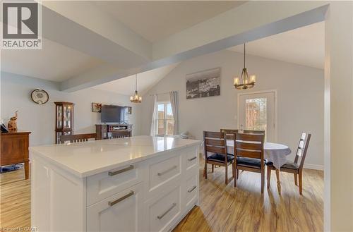 Central kitchen island featuring a light-toned countertop and white cabinetry - 512 Hidden Creek Drive, Kitchener, ON - Indoor Photo Showing Dining Room