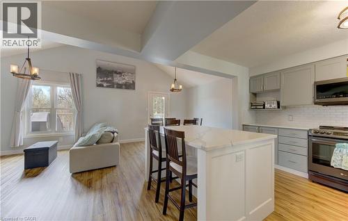 Open-concept living space featuring wood-finish flooring, vaulted ceilings with exposed beams, and a modern kitchen - 512 Hidden Creek Drive, Kitchener, ON - Indoor Photo Showing Kitchen
