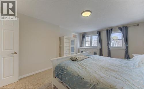 Carpeted bedroom with neutral wall tones and a white interior door - 512 Hidden Creek Drive, Kitchener, ON - Indoor Photo Showing Bedroom