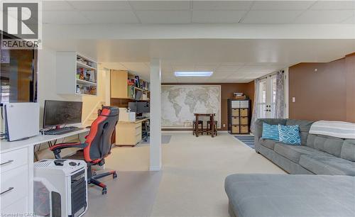Finished lower level featuring recessed lighting, an integrated desk area, built-in shelving, durable carpeting, and French patio doors - 512 Hidden Creek Drive, Kitchener, ON - Indoor Photo Showing Office