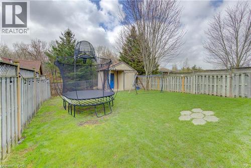 Expansive green lawn with mature perimeter trees and privacy fencing - 512 Hidden Creek Drive, Kitchener, ON - Outdoor
