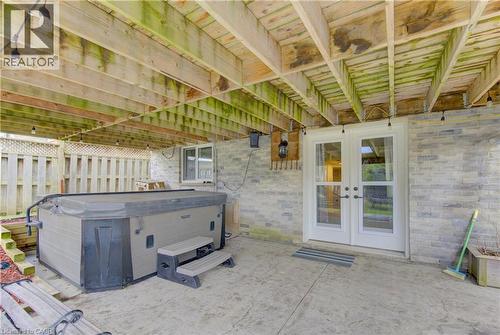 Covered patio area with steps, stamped concrete flooring, and a privacy fence - 512 Hidden Creek Drive, Kitchener, ON -  With Exterior