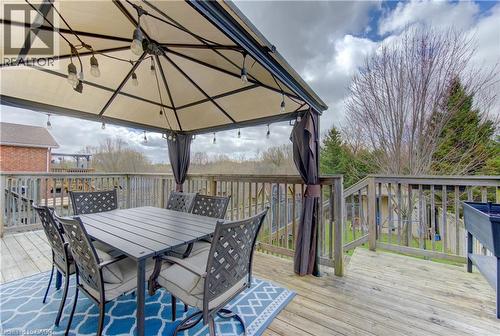 Expansive wooden deck featuring a built-in gazebo with string lighting, wooden railing, and an outdoor planter box - 512 Hidden Creek Drive, Kitchener, ON - Outdoor With Deck Patio Veranda With Exterior