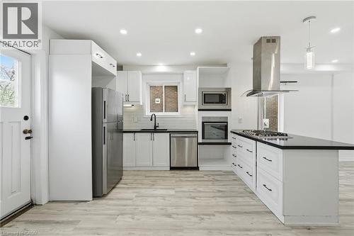 Spacious kitchen with access to yard - 73 Gertrude Street, Hamilton, ON - Indoor Photo Showing Kitchen With Upgraded Kitchen