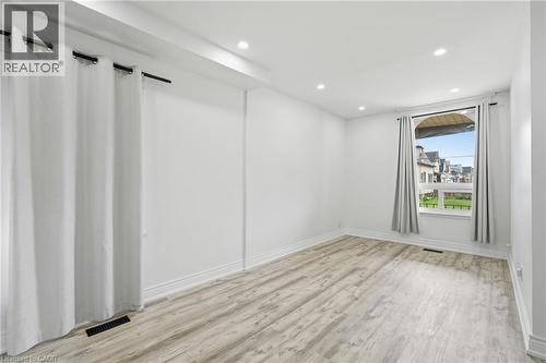 large windows with curtain panels for privacy - 73 Gertrude Street, Hamilton, ON - Indoor Photo Showing Other Room