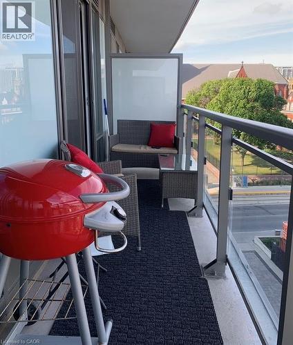 Private balcony featuring glass railings and a textured floor mat - 85 Duke Street W Unit# 507, Kitchener, ON - Outdoor With Balcony With Exterior