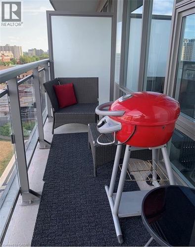 Balcony featuring concrete flooring, a glass and metal railing, and a frosted privacy panel - 85 Duke Street W Unit# 507, Kitchener, ON - Outdoor With Balcony With Exterior