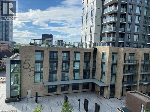 Modern multi-story building featuring light brickwork and dark-framed windows - 85 Duke Street W Unit# 507, Kitchener, ON - Outdoor With Balcony With Facade