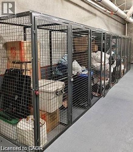 Secure caged storage units with concrete flooring and exposed ceiling utilities - 85 Duke Street W Unit# 507, Kitchener, ON - Indoor